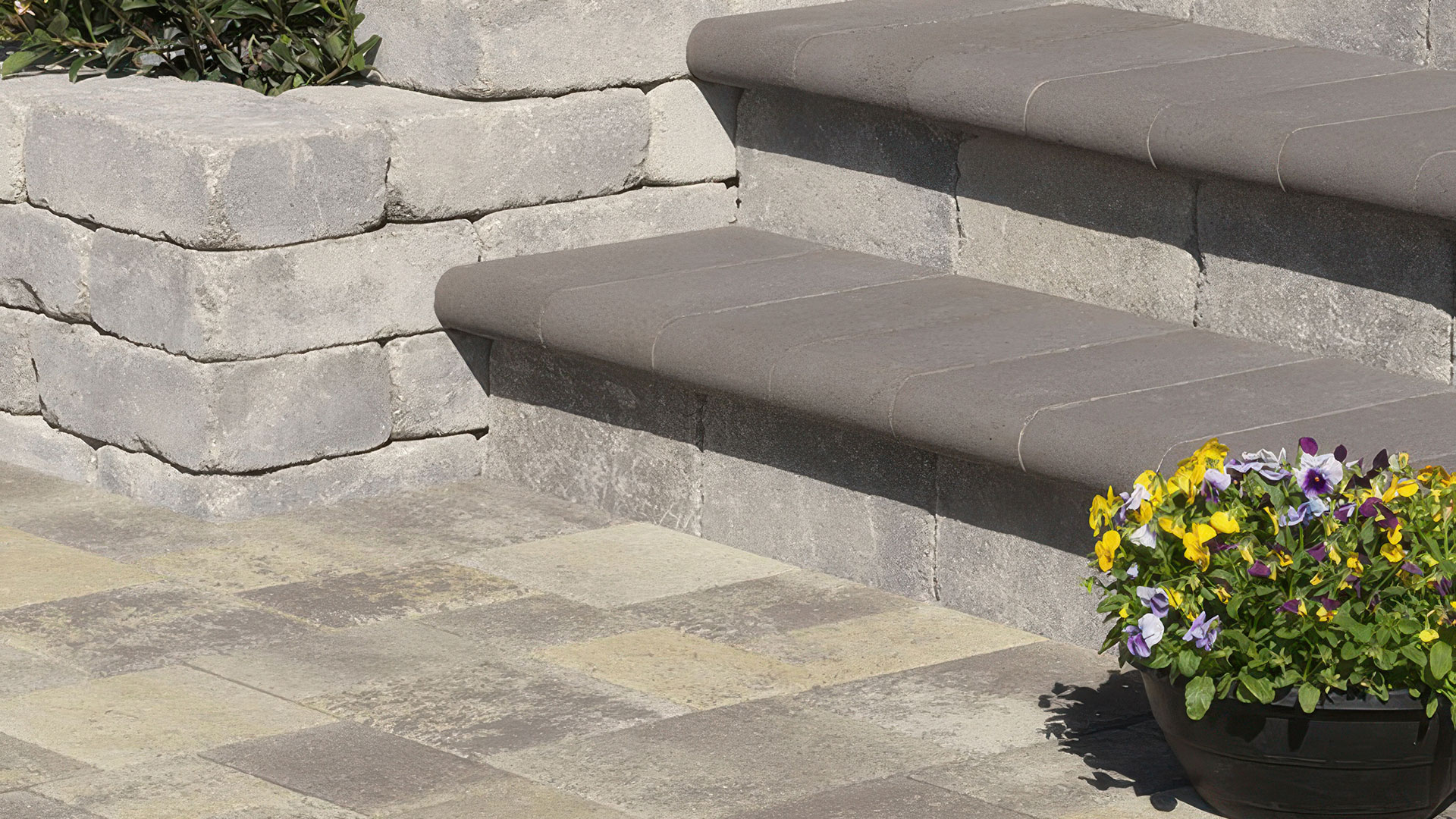 steps covered with blended gray moss charcoal 6 by 14 bullnose coping paving stones rounded edge exposed.