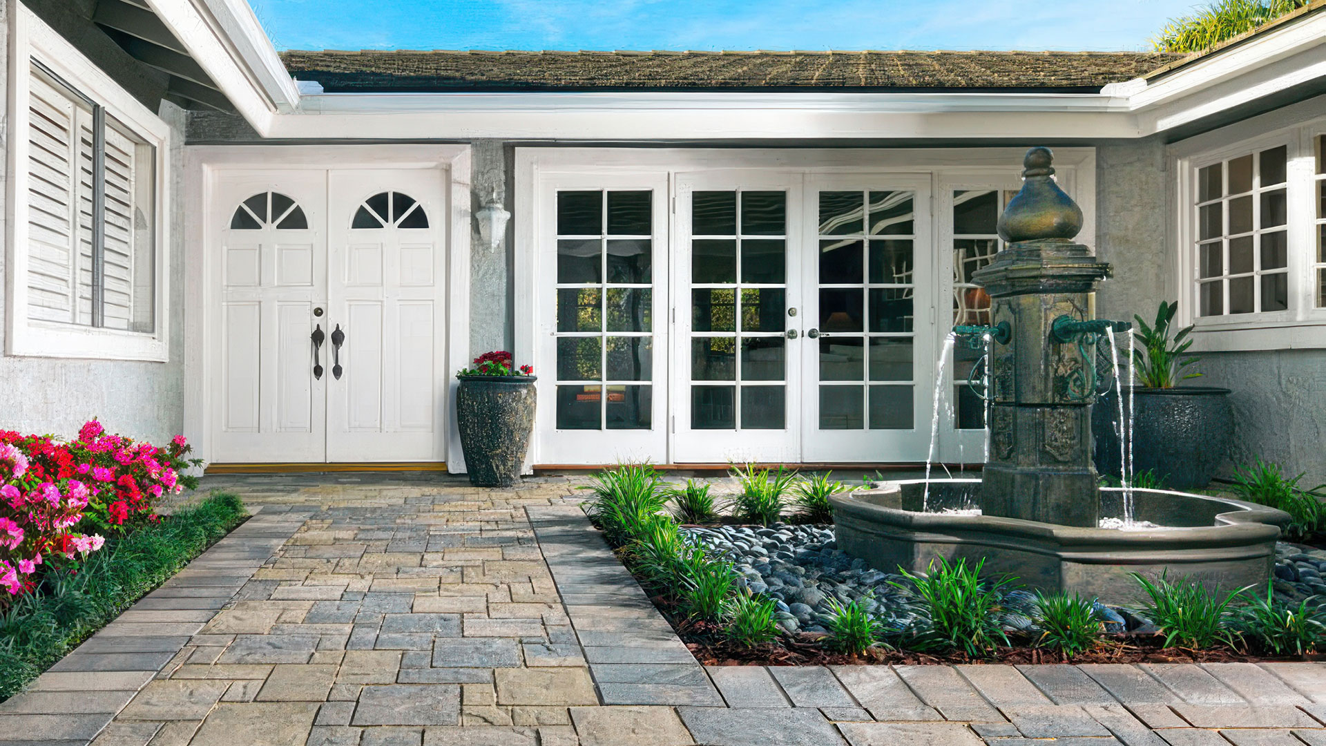 Gray Moss Charcoal Heartland paving stones installed in a ashlar pattern. Courtyard and entryway to home.