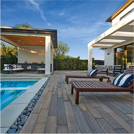 an amazing backyard patio and pool deck with outdoor pool and entertainment area. Patio and pool deck are covered in blended stone adobe mocha timberline paving stones.