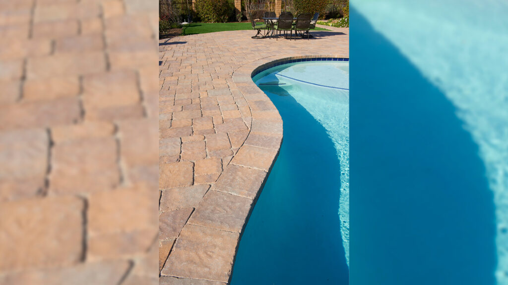 Close-up view of pool coping showcasing a tumbled finish with Tuscan Estate Cobble I and II pavers arranged in an ashlar pattern. The coping is composed of tumbled Tuscan Estate Cobble II, displaying a natural, weathered texture and warm, earthy tones that lend a rustic, timeless appeal to the pool edge.