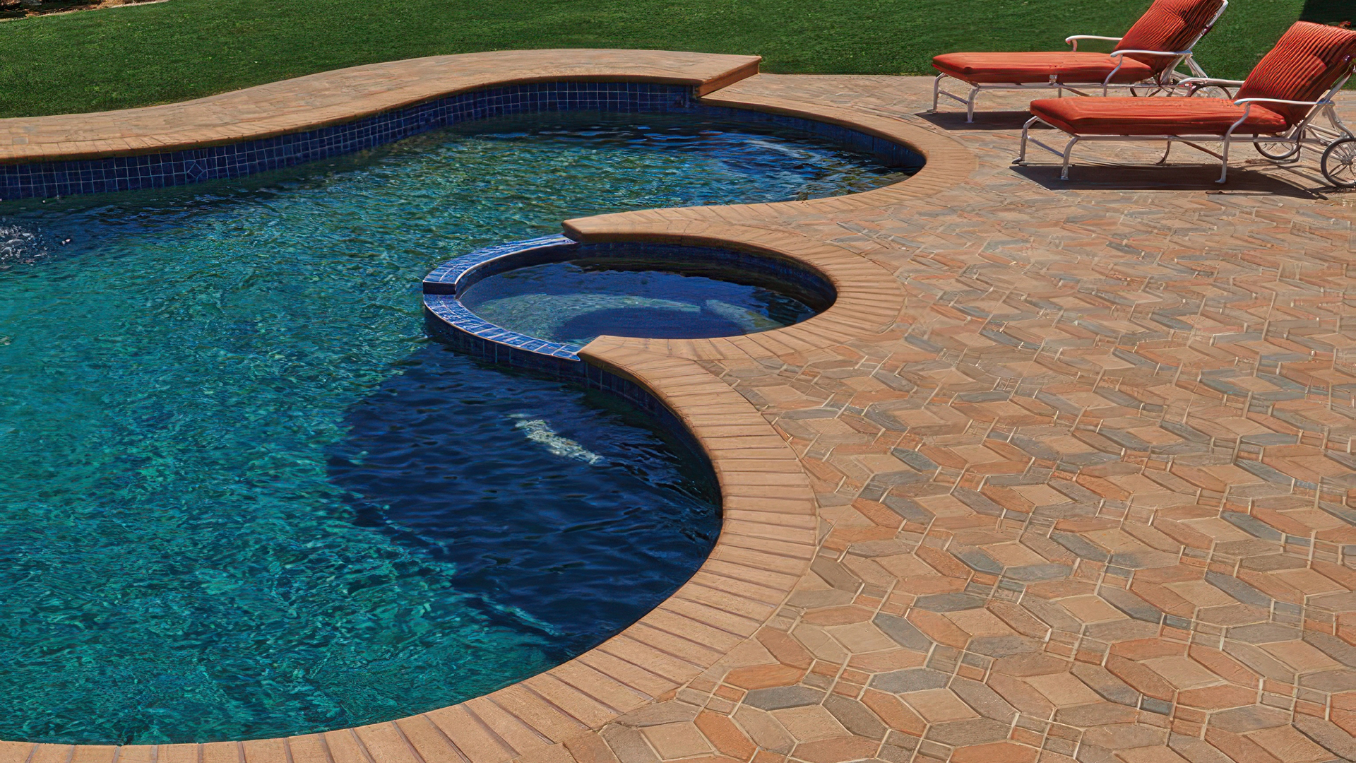 Poolside patio featuring a 50/50 field mix of Cream-Terracotta-Brown and Cream-Brown-Charcoal Symetry pavers, with solid Cream 6x6 accent pieces, all arranged in a Venetian parquet pattern. The pool coping is finished with solid Cream bullnose coping for a clean, rounded edge.