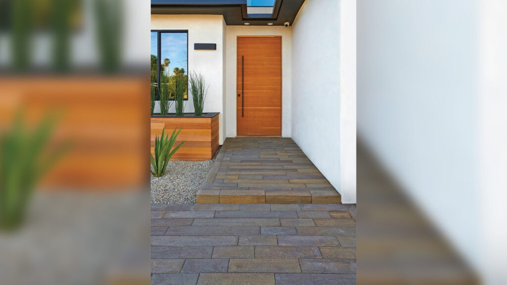 Modern front entryway paved with Stone-Adobe-Mocha 70mm Timberline pavers installed in a random running bond pattern. Clean white stucco walls and wood accents create a contemporary contrast with the multitone paving.