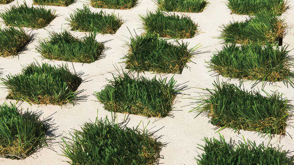 Close-up of Gray Turfstone filled with artificial turf, showcasing a greenbelt appearance with minimal maintenance and water usage.