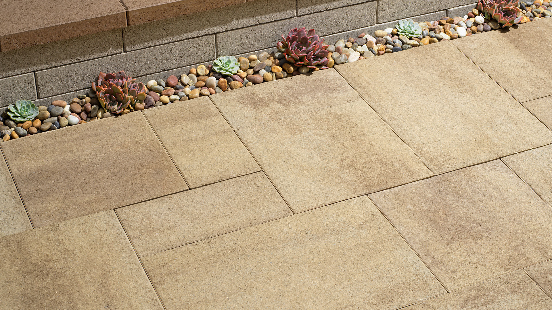 New blended light sand gray stone porcellana 18 inch paving stones installed in a random ashlar pattern.