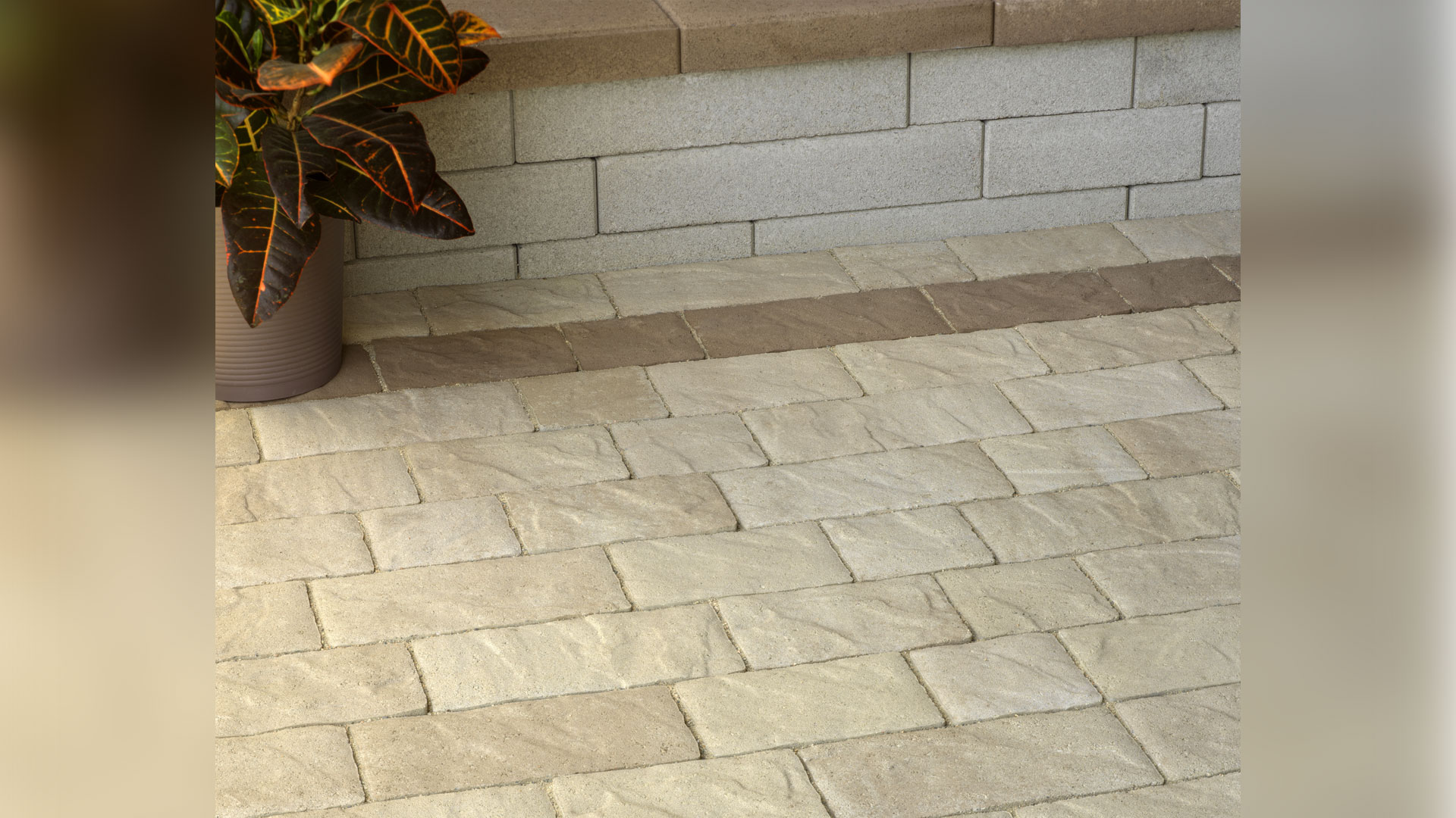 Light Sand-Gray-Stone Portofino paving stones installed in a random runner pattern with a Mocha Portofino accent border stripe.